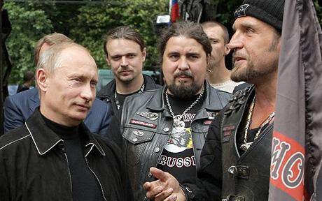 Russia's Prime Minister Putin listens as Zaldostanov, president of motorcycling club Night Wolves, gestures while speaking at the club in Moscow...Russia's Prime Minister Vladimir Putin (L) listens as Alexander Zaldostanov (R), president of the motorcycling club Night Wolves, gestures while speaking at the club in Moscow, July 7, 2009. The club will take part in the 13th International Bike Show in the Ukrainian Black Sea port of Sevastopol, an event dedicated to the 65th anniversary of the liberation from Nazi troops. Zaldostanov also goes by the nickname "Khirurg", which means "surgeon". REUTERS/RIA Novosti/Alexei Druzhinin/Pool (RUSSIA POLITICS SOCIETY)